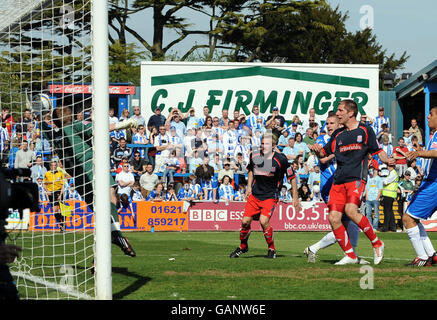 Colchester United`s Dean Gerken (left) saves a header from Stoke City's Richard Cresswell (2nd right) but the ball is bundled in the net on the rebound during the Coca-Cola Football Championship match at Layer Road, Colchester. Stock Photo
